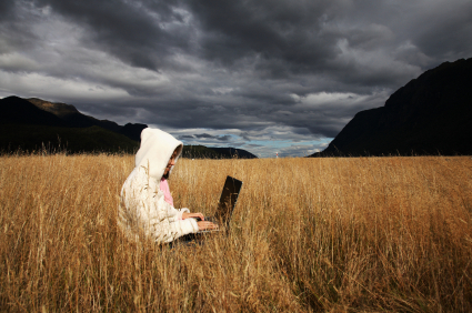 woman-using-laptop-out-in-field-with-wifi.jpg